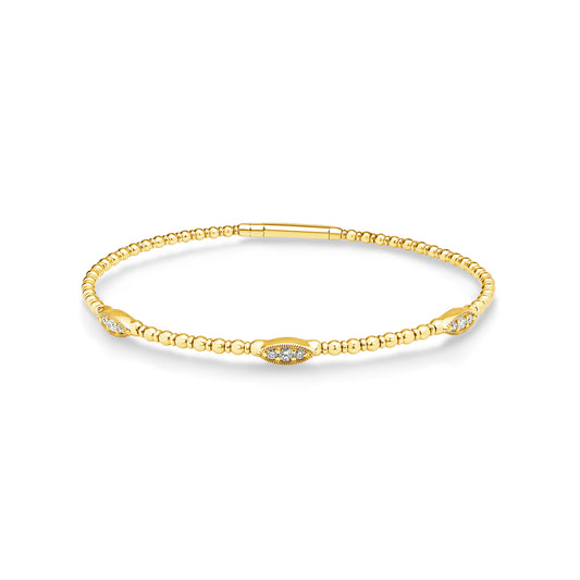 14ct yellow gold granule style bangle featuring 9 diamonds set into 3 oval shaped stations weighing a total of 0.20ct. Flexi-style bangle with easy close clasp