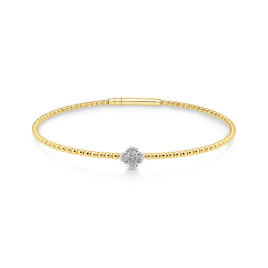 14ct yellow gold granule style bangle featuring 5 diamonds set into one white gold clover shaped station weighing a total of 0.10ct. This Flexi-style bangle has an easy close clasp