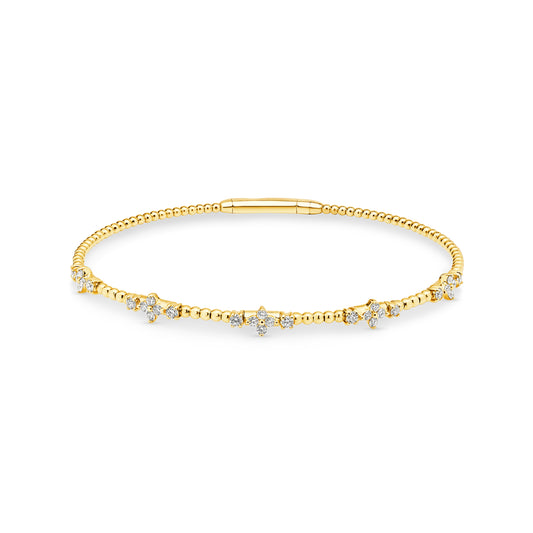 14ct yellow gold granule style bangle featuring 30 diamonds set into soft floral starburst arrangements weighing a total of 0.48ct. Flexi-style bangle has an easy close clasp